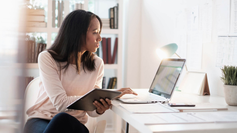 Mixed race businesswoman using laptop