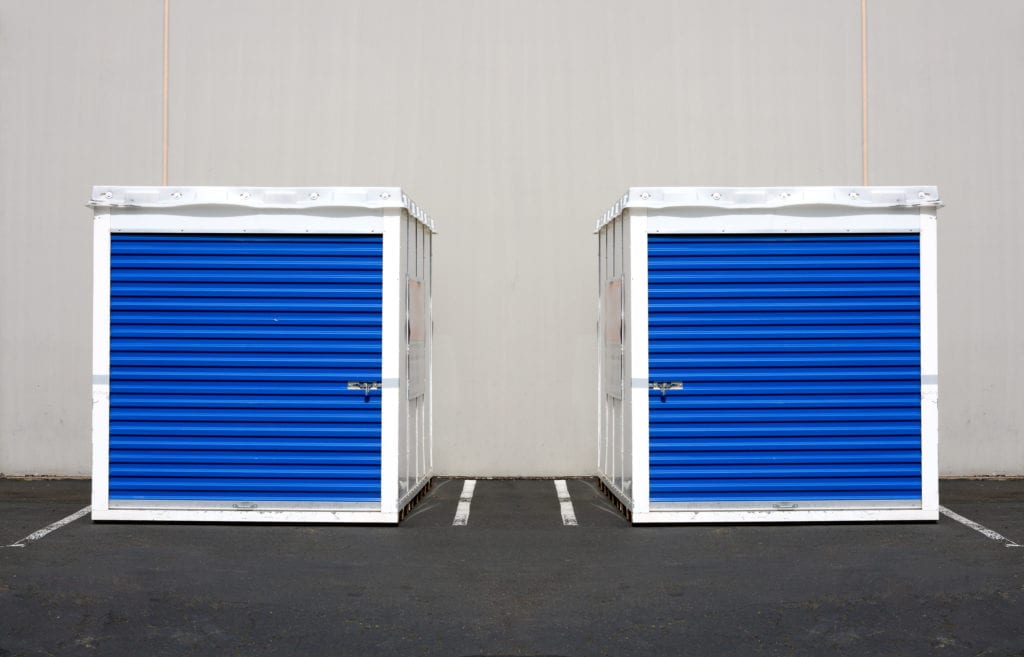 Two storage pods in parking lot